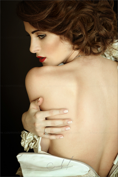 Boudoir mood portrait of a bride with red lips