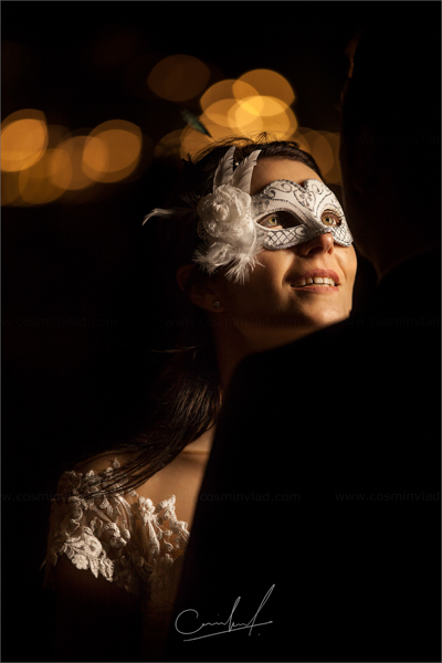 Bride wearing a masque for her destination wedding in Venice and looking lovigly at her husband